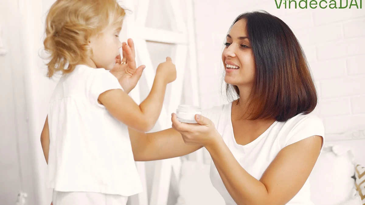 Mama punand crema pe fata fetitei sale